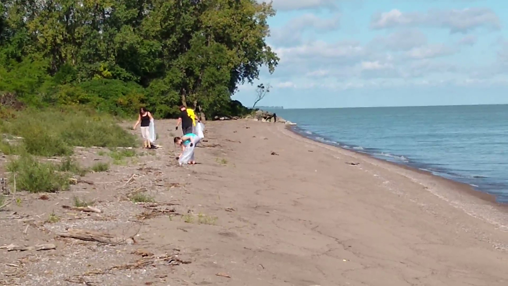 Family helping to clear trash from the Wildlife Beach.